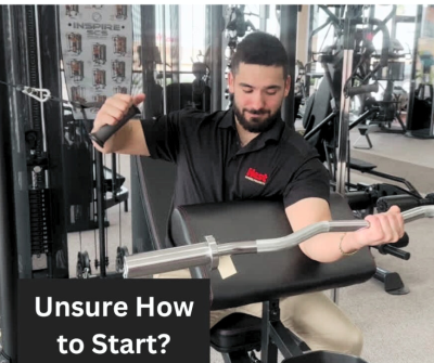 Jeremy Villareal demonstrating how strength training beginners might be confused with a preacher curl and cable press