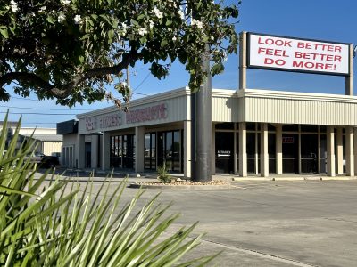 Hest Fitness Products Corpus Christi Store on April 12_2024 with sunshine and flowers on tree.